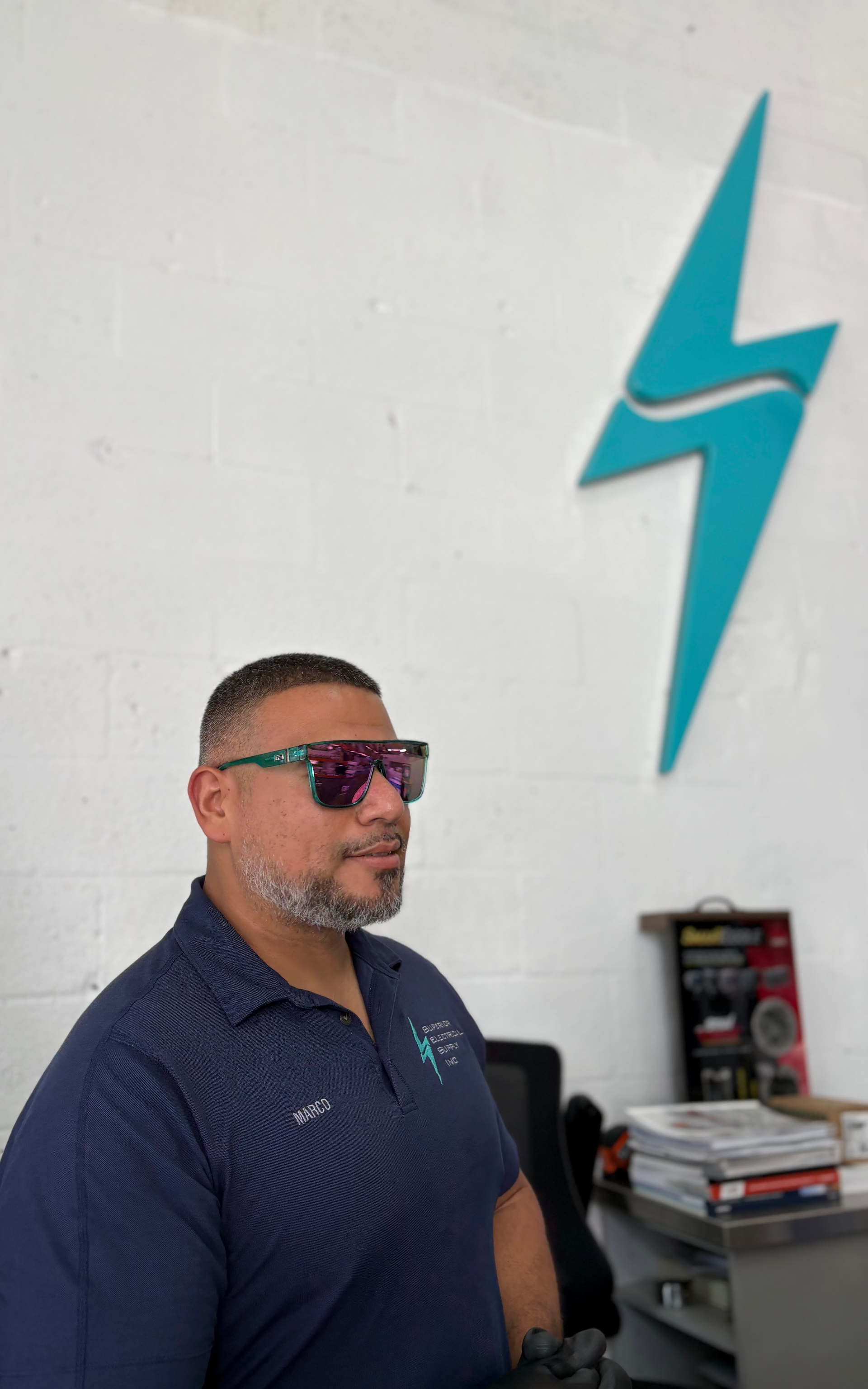 Marco Sanchez at Superior Electrical Supply counter in Miami Florida helping customers with electrical supplies and expert product advice
